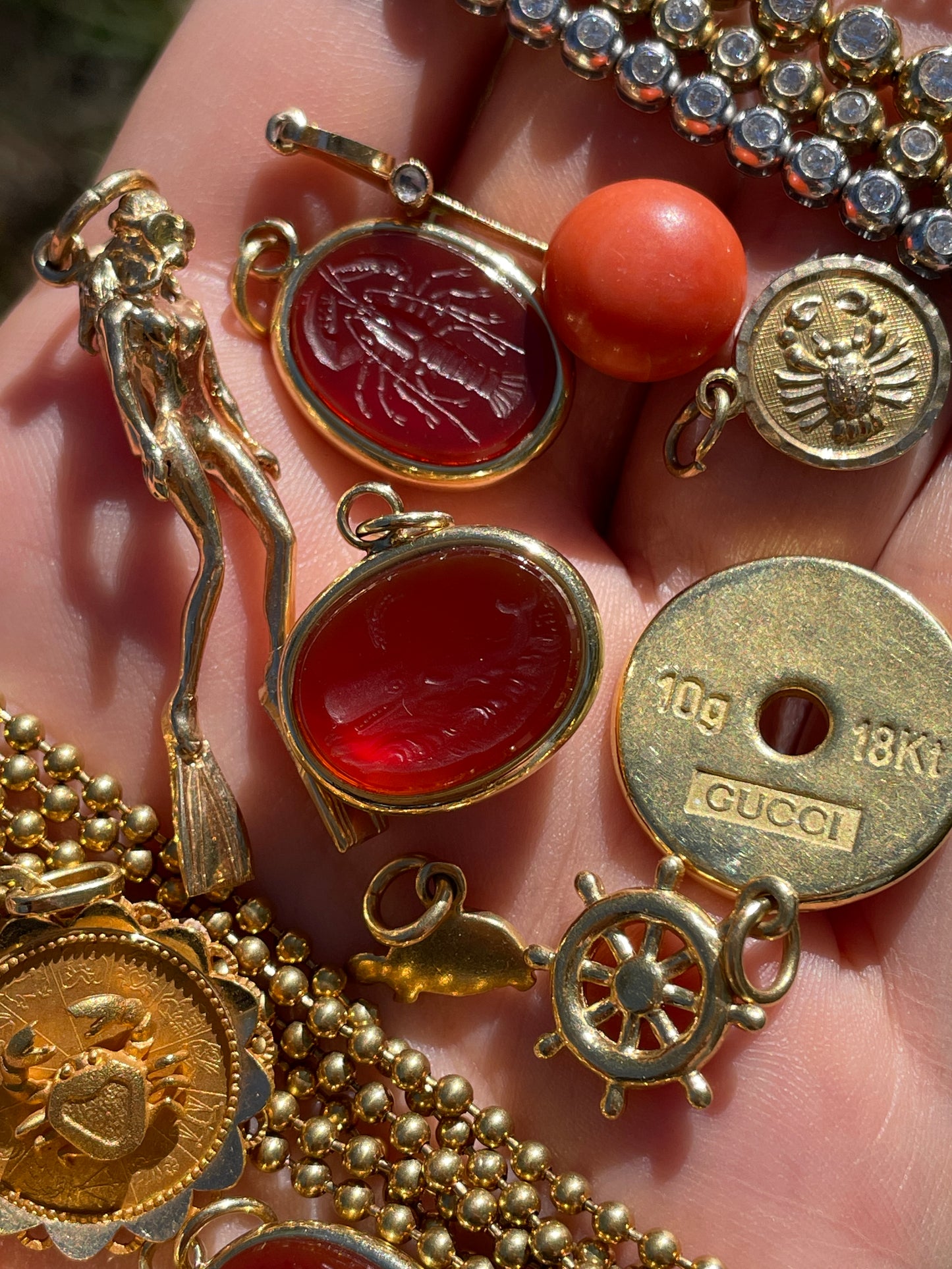 Vintage yellow 18K carved carnelian aquatic animal pebble pendants