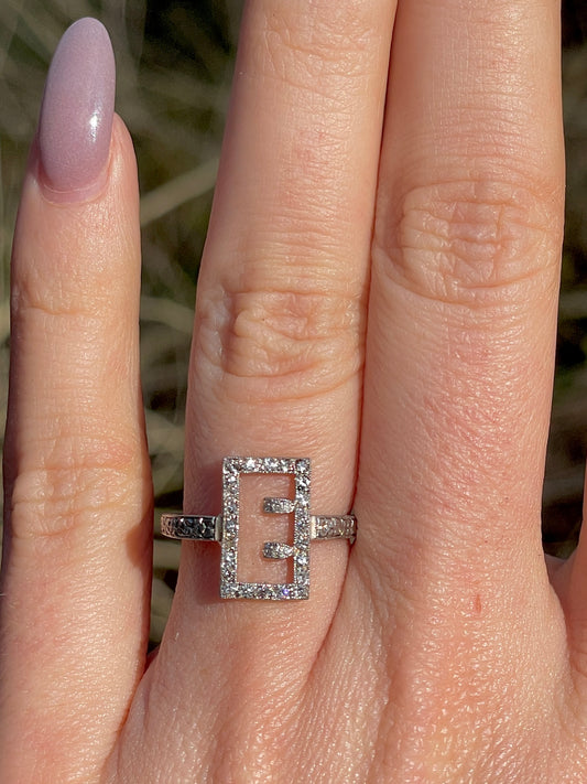 Antique platinum and .17 ctw diamond buckle or E initial ring, size 6