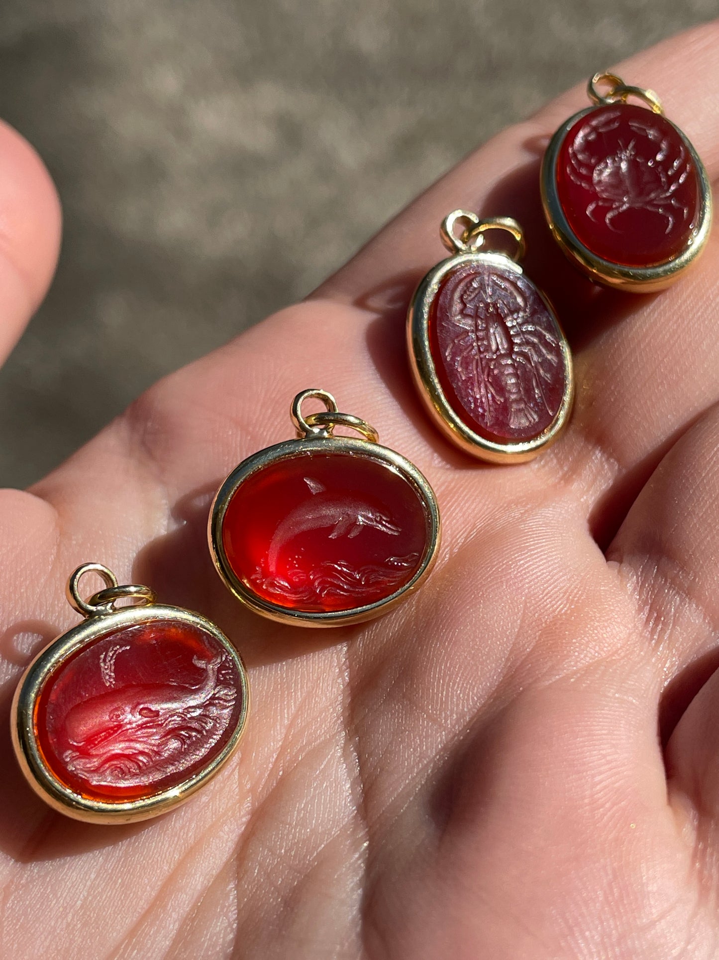 Vintage yellow 18K carved carnelian aquatic animal pebble pendants
