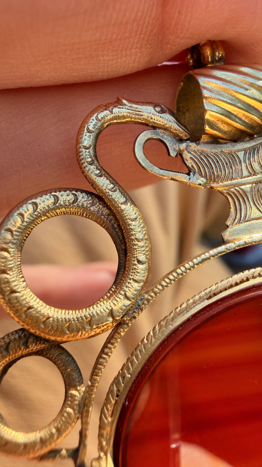 Antique yellow 18K swiveling double snake with urn carnelian pendant