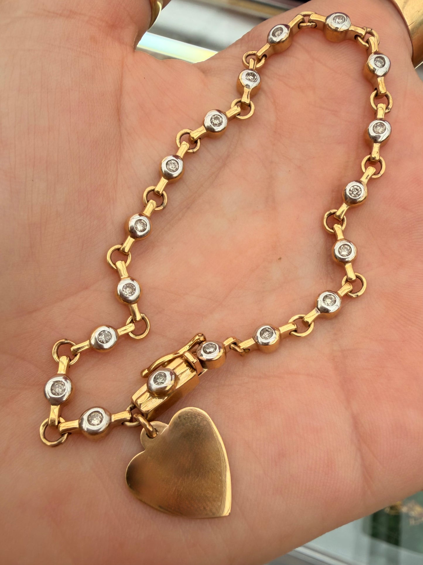 Vintage 10K approx .54ctw diamond bezel tennis bracelet with heart charm, 7.25 inch