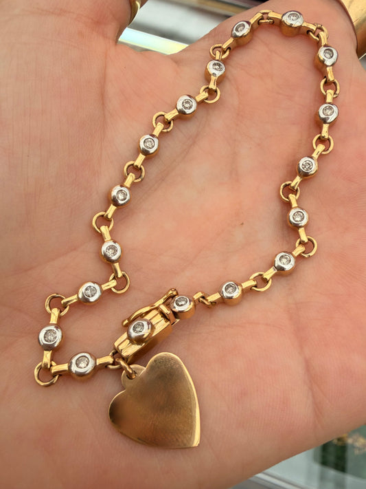 Vintage 10K approx .54ctw diamond bezel tennis bracelet with heart charm, 7.25 inch