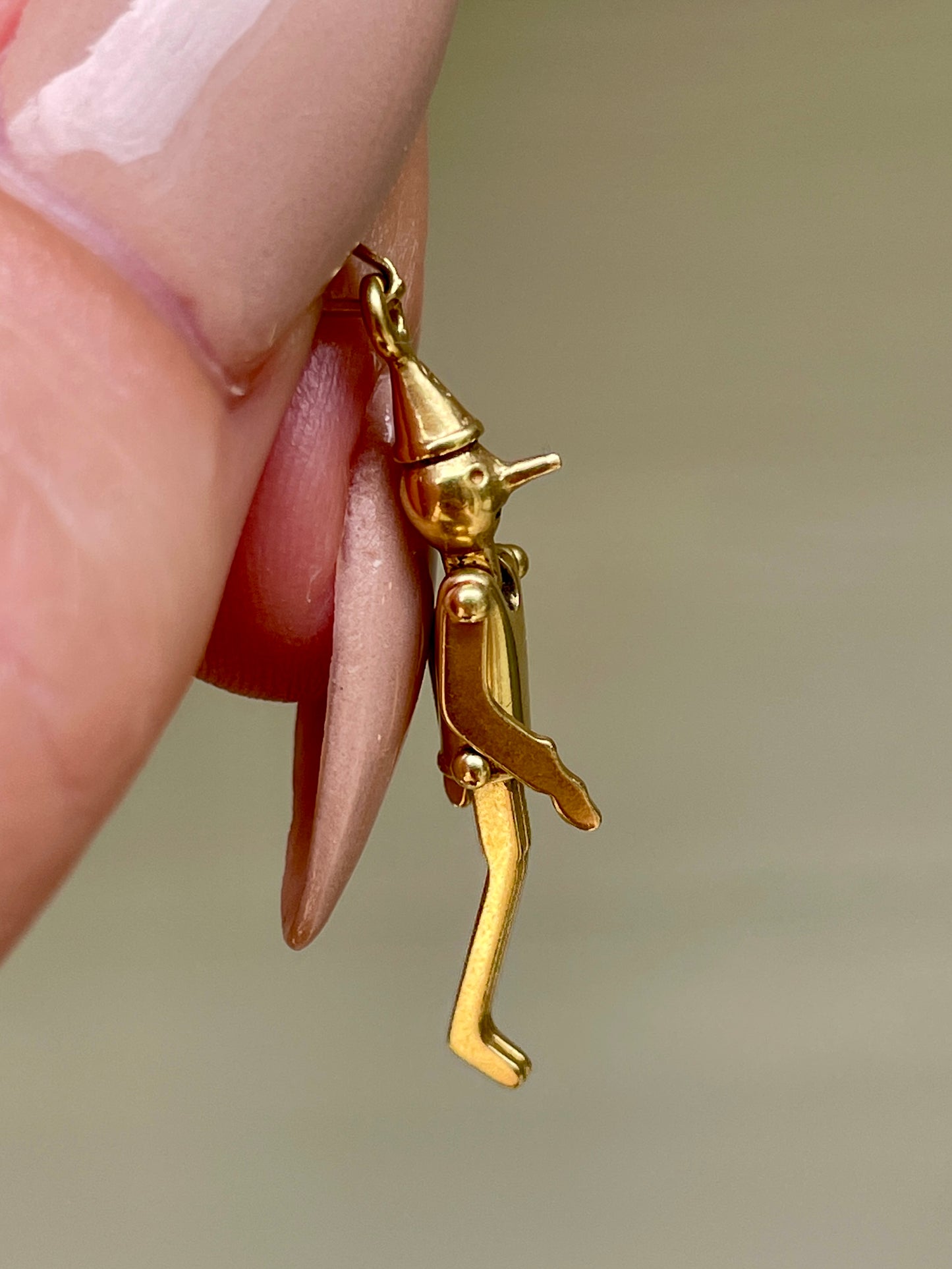 Vintage yellow 18K articulated Pinocchio charm