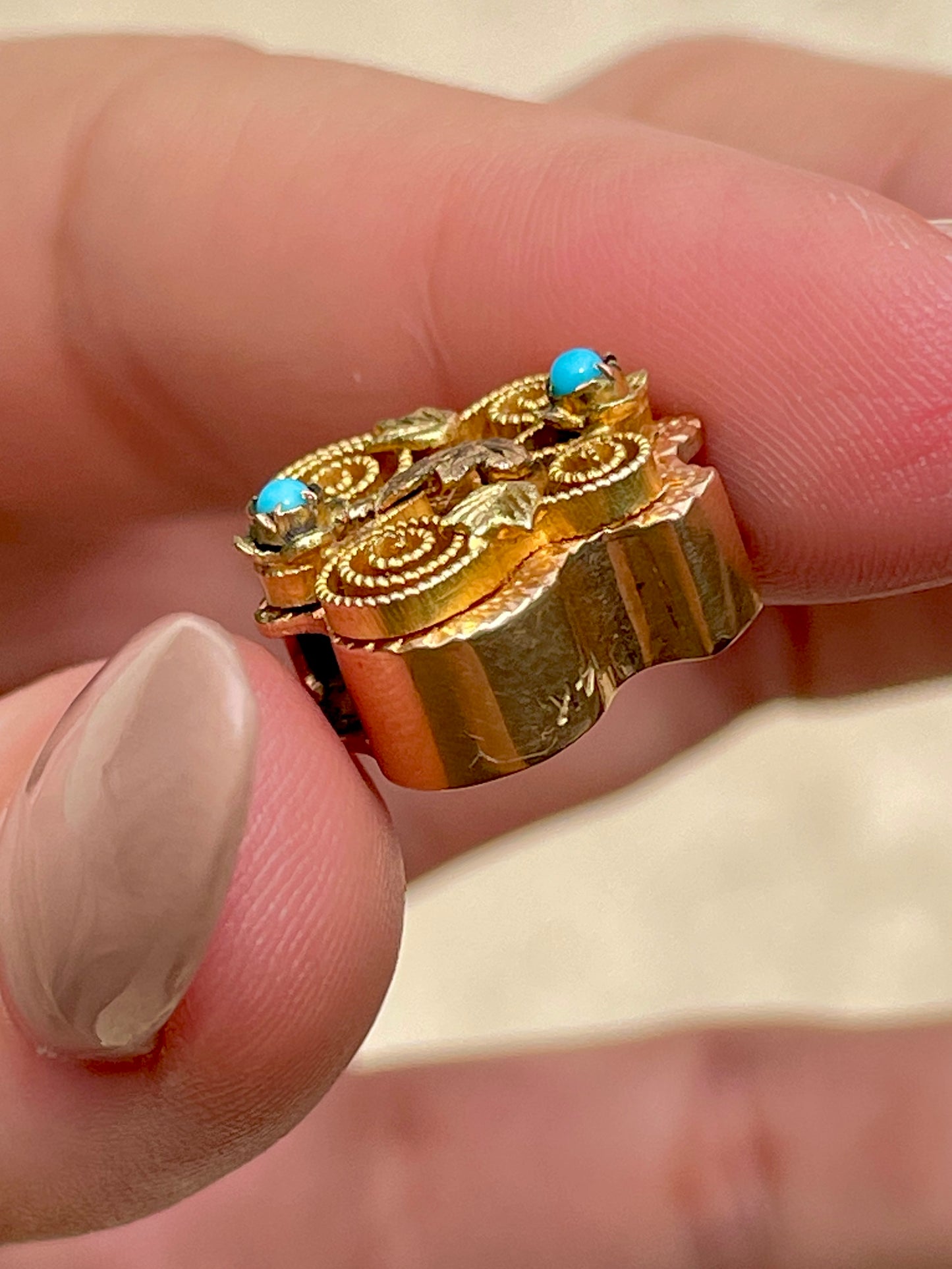 Antique yellow 14K crest shaped slider with leaves and turquoise details