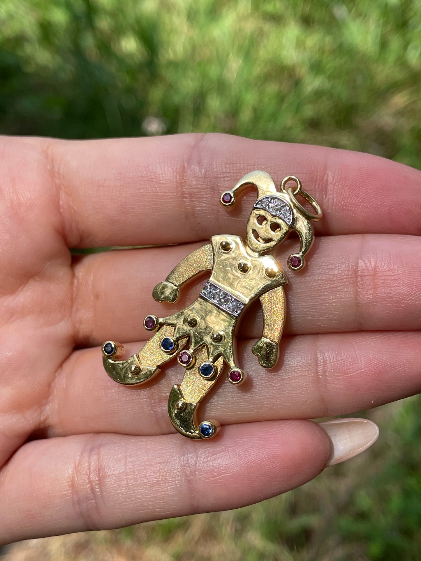 Vintage yellow 18K articulated Jester pendant with rubies, sapphires and diamonds