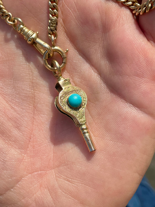 Antique yellow 9K turquoise watch key with floral engraving from 1893