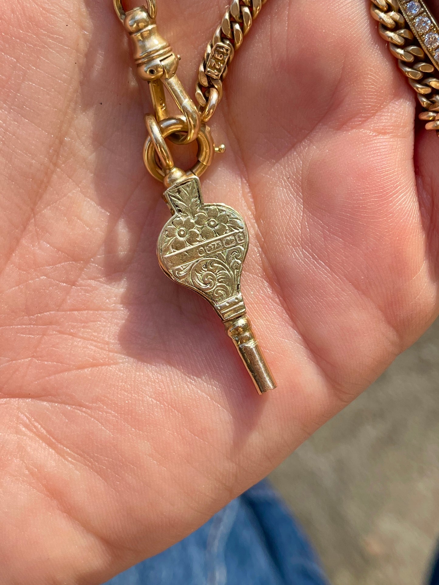 Antique yellow 9K turquoise watch key with floral engraving from 1893