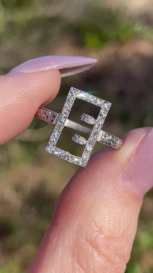 Antique platinum and .17 ctw diamond buckle or E initial ring, size 6