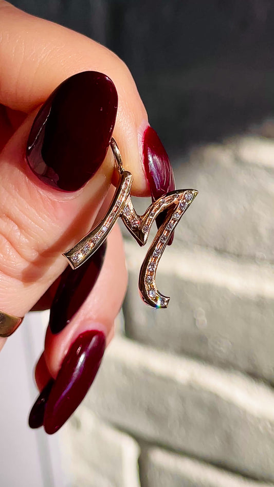 Vintage yellow 14K letter M charm with approx .3 ctw diamonds