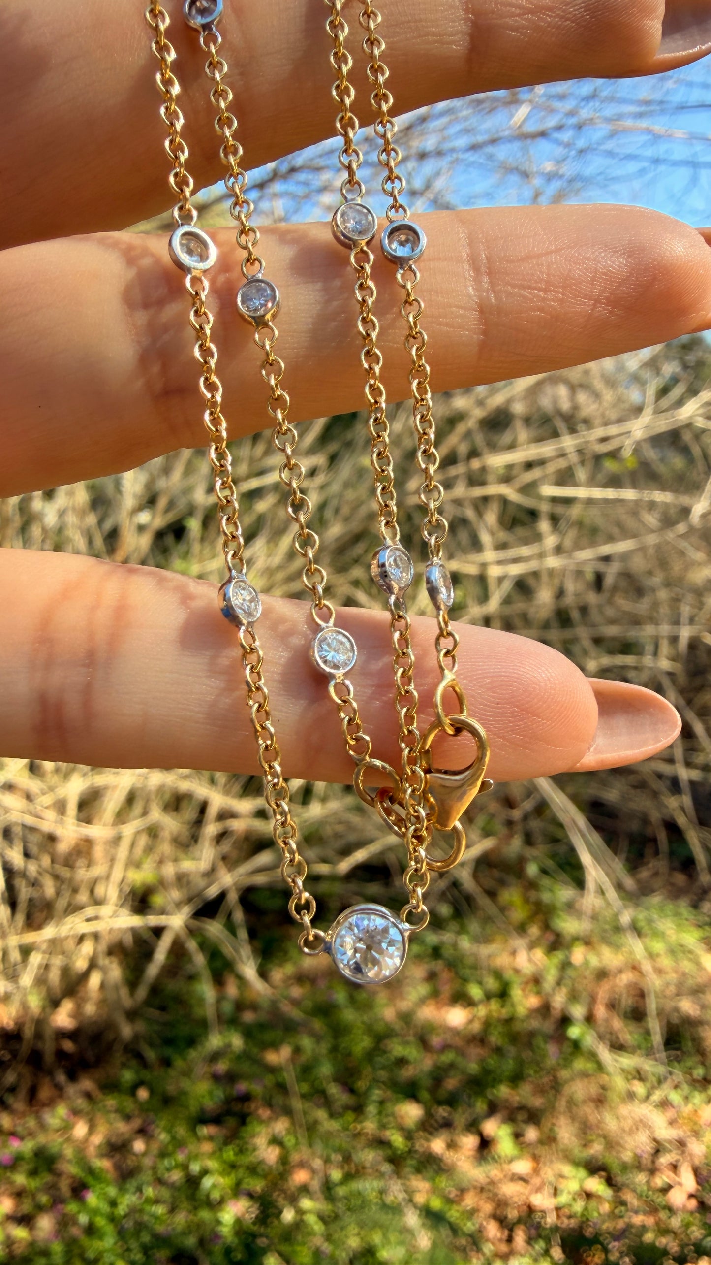 Vintage 18K approx 1.2ctw Old European Cut diamond and round diamond station chain, 18 3/8 inch