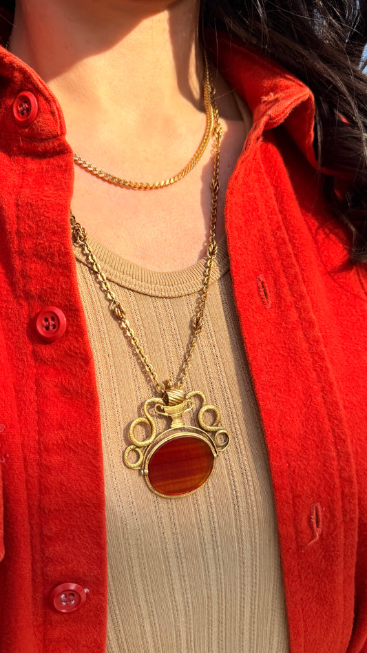 Antique yellow 18K swiveling double snake with urn carnelian pendant