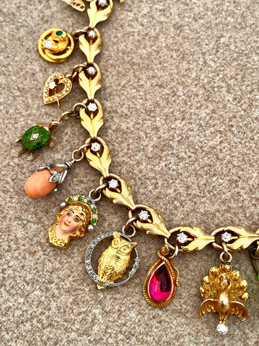 Antique yellow 18K and 14K charm bracelet with old mine cut diamonds, pearls, gemstones and enamel