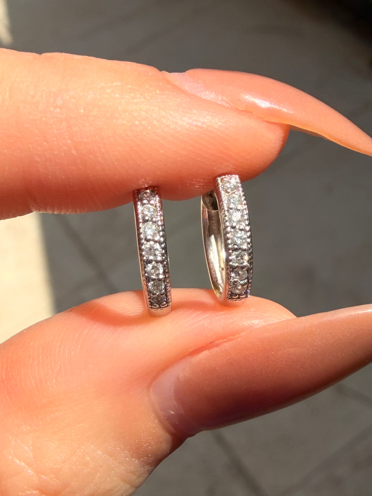 Vintage white 18K approx .13ctw diamond huggies with milgrain detail