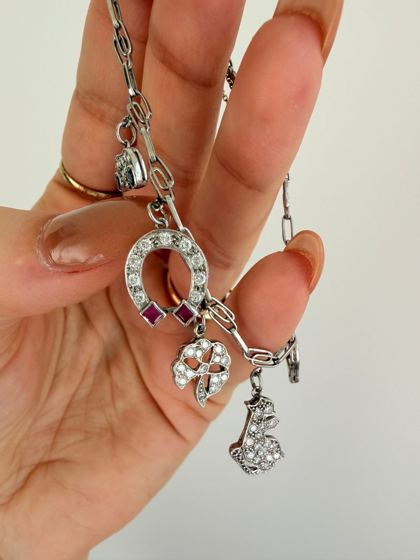 Antique platinum Art Deco charm bracelet with 1 ctw diamonds, sapphires and rubies, 7 inch