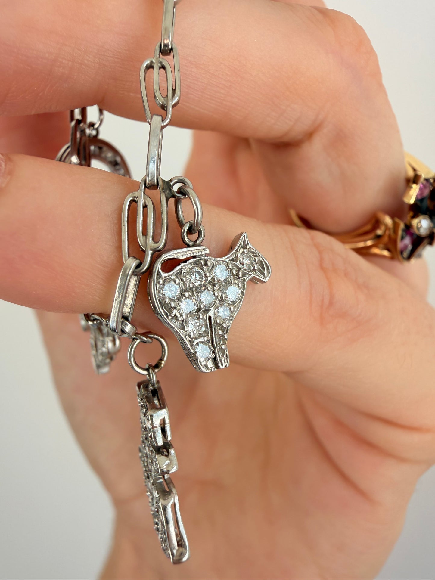 Antique platinum Art Deco charm bracelet with 1 ctw diamonds, sapphires and rubies, 7 inch