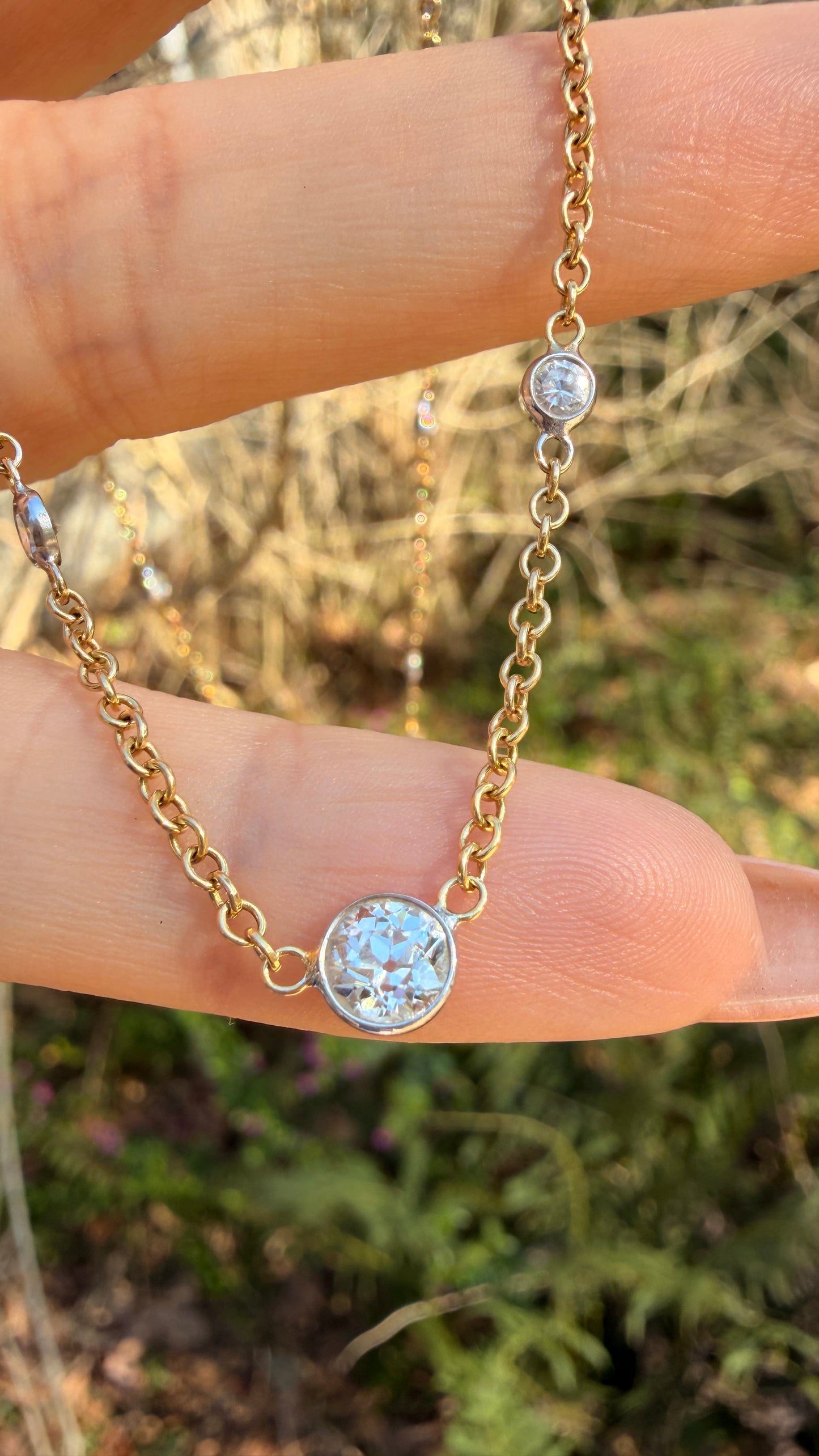 Vintage 18K approx 1.2ctw Old European Cut diamond and round diamond station chain, 18 3/8 inch