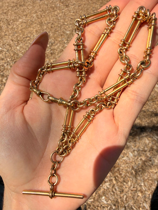 Antique yellow 18K fancy trombone watch chain with double dog clips, 19 and 1/8 inch long with extra link for extension