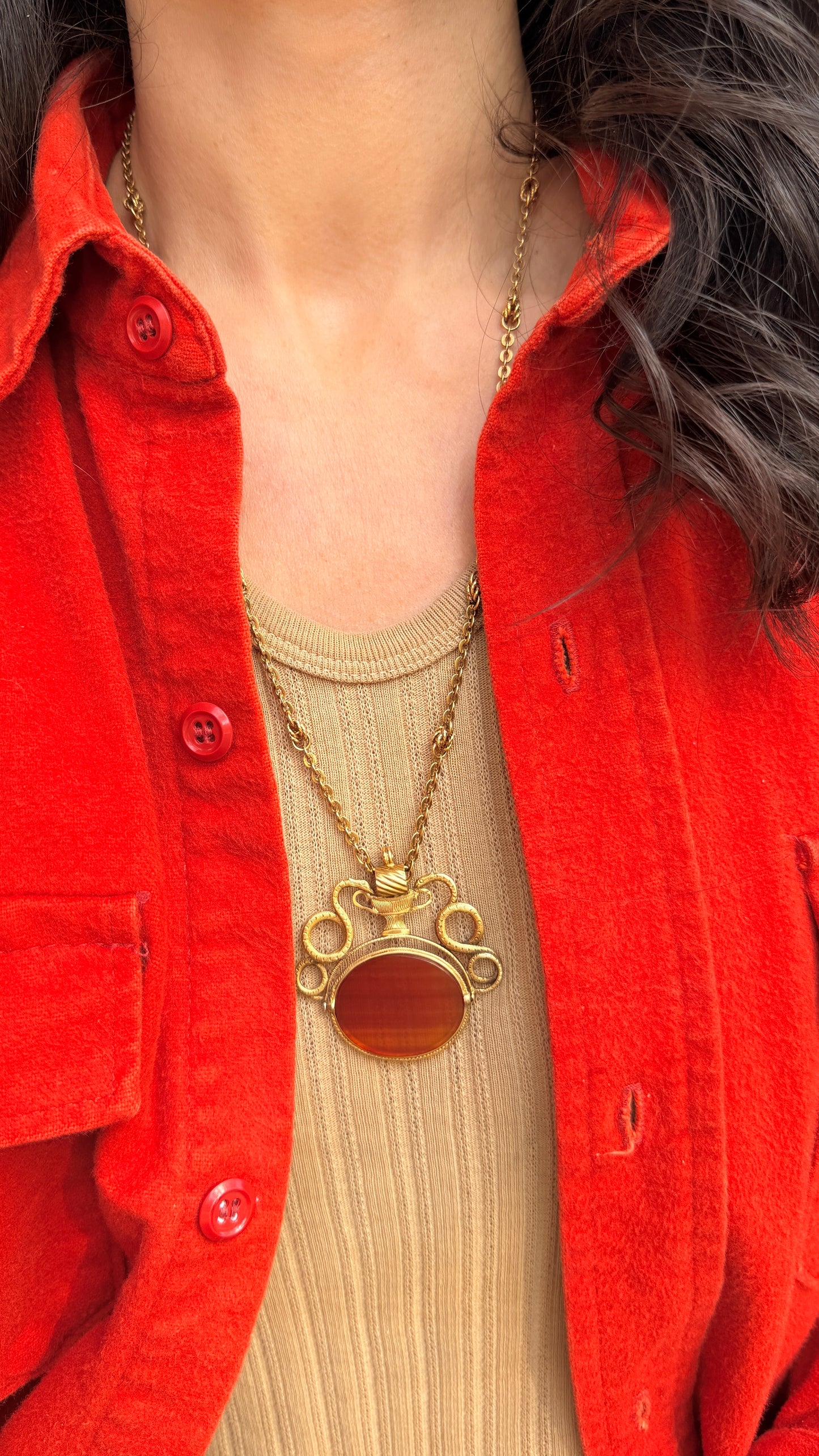 Antique yellow 18K swiveling double snake with urn carnelian pendant