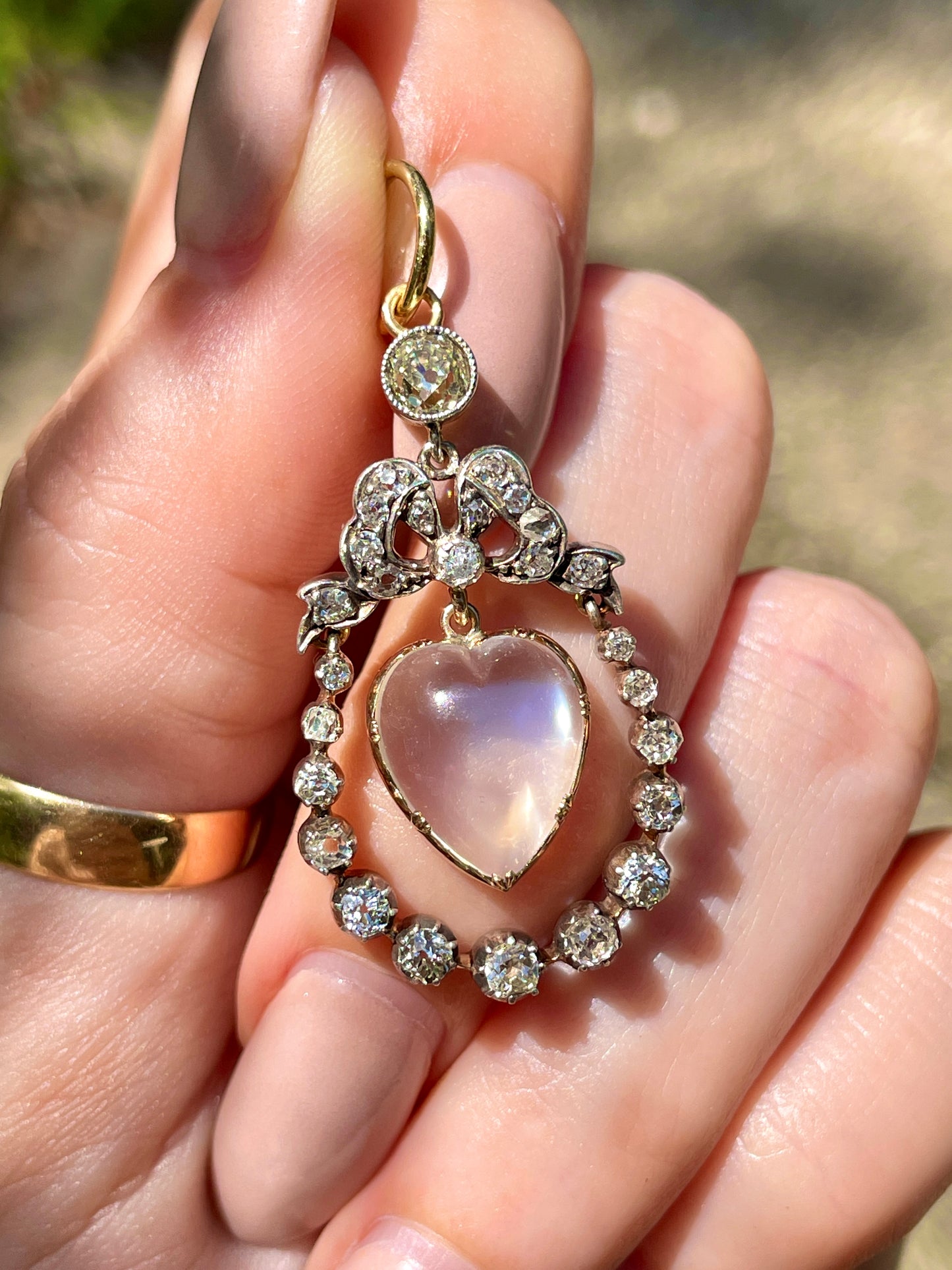 Incredible Antique 18K and 14K approx 1.22 ctw diamond and heart shaped moonstone bow pendant