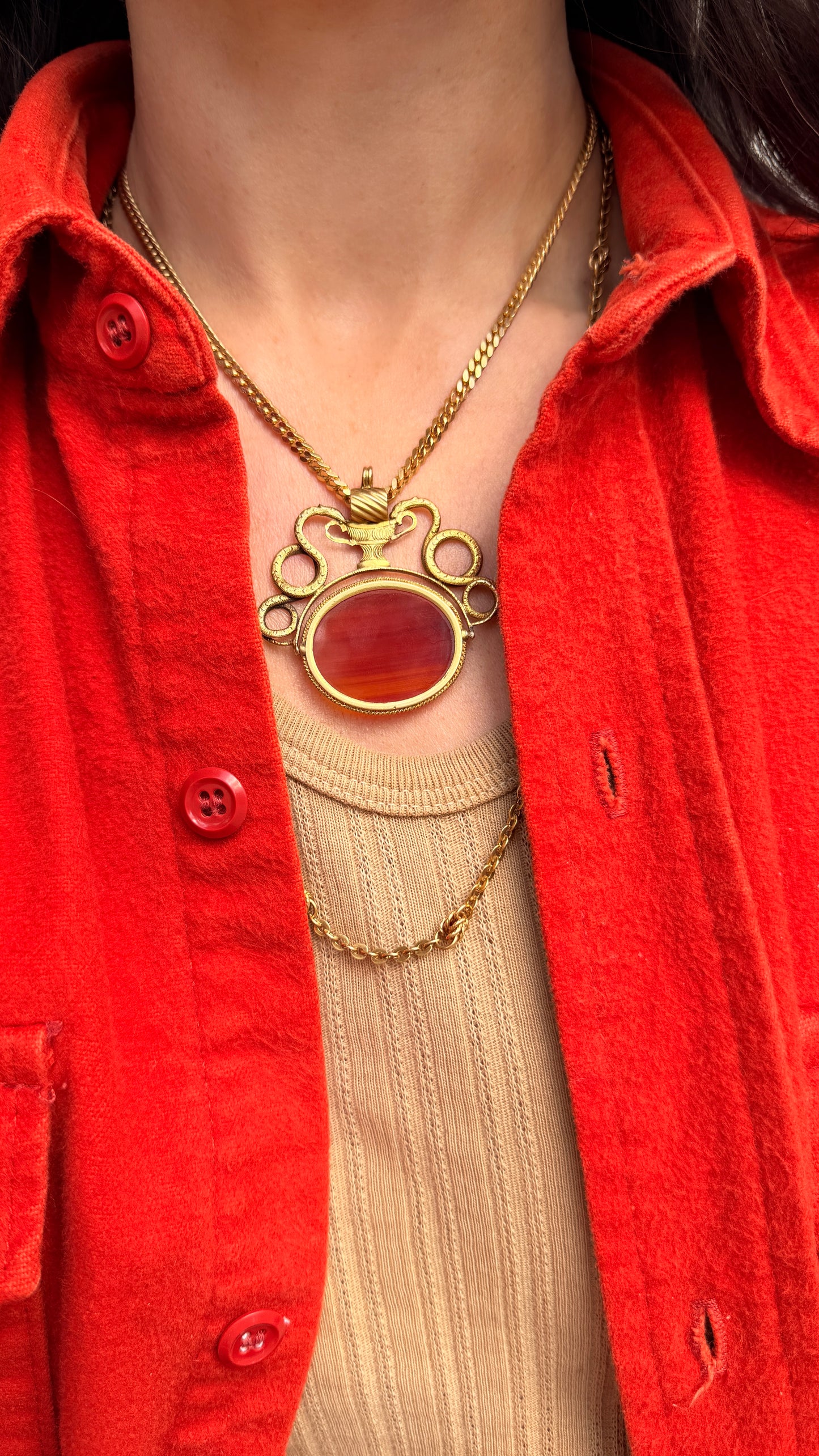 Antique yellow 18K swiveling double snake with urn carnelian pendant