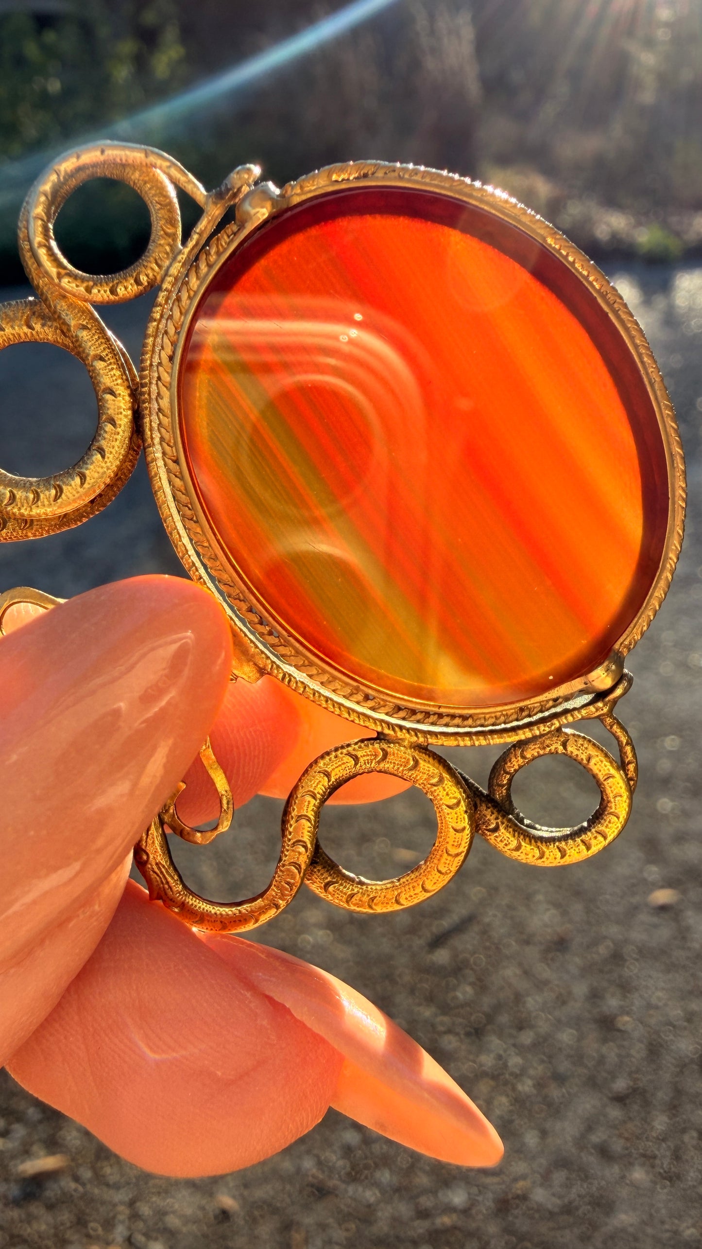 Antique yellow 18K swiveling double snake with urn carnelian pendant