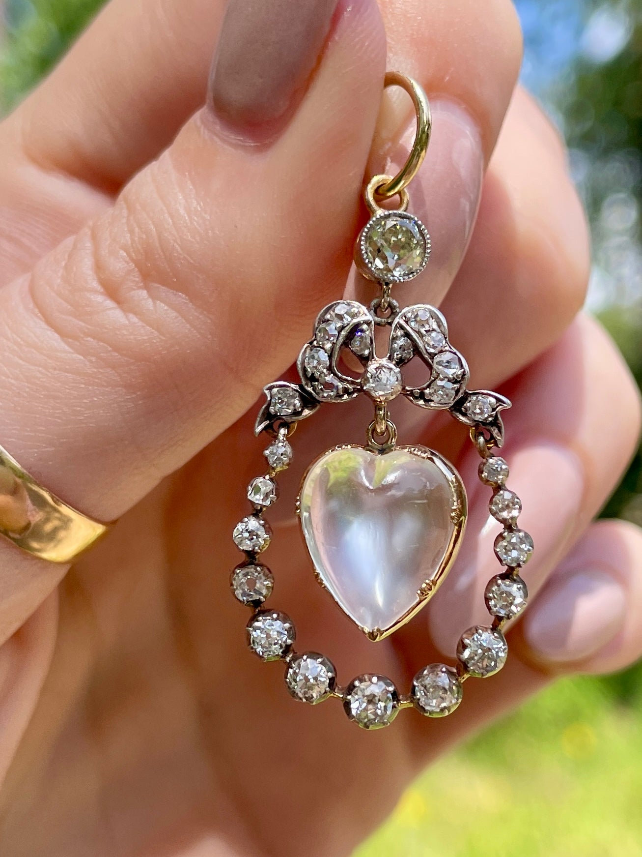 Incredible Antique 18K and 14K approx 1.22 ctw diamond and heart shaped moonstone bow pendant