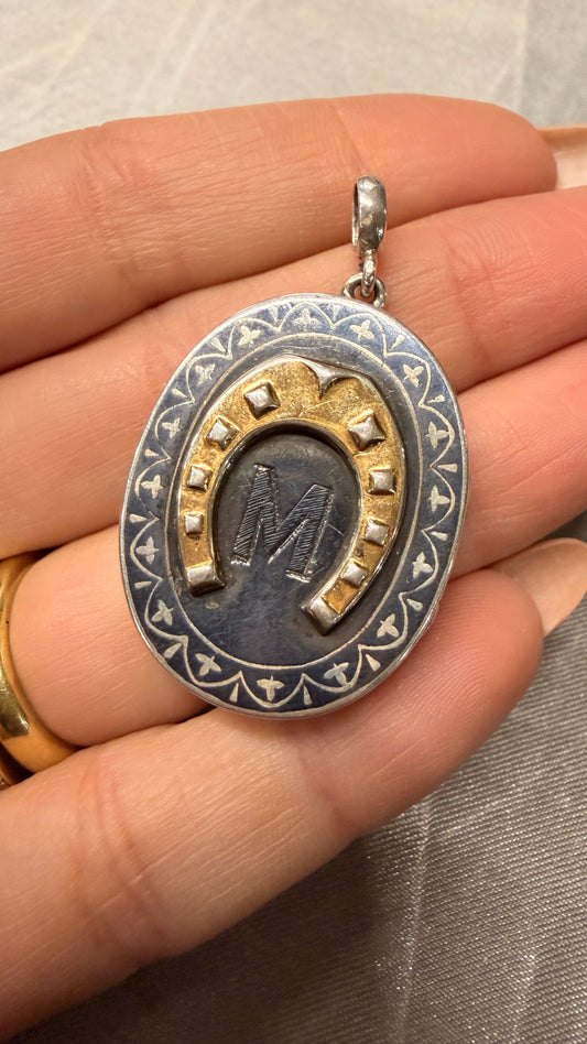 Antique silver niello and 9K gold horseshoe locket with M initial