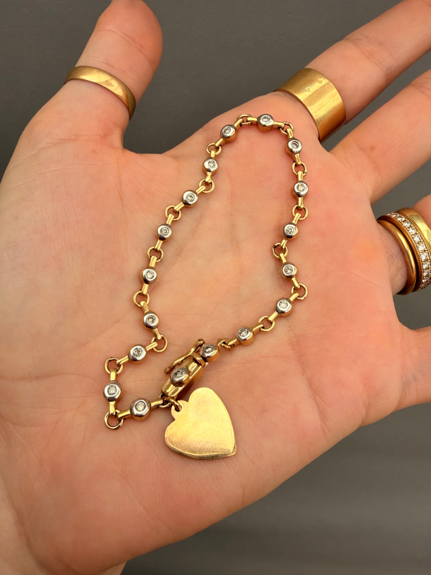 Vintage 10K approx .54ctw diamond bezel tennis bracelet with heart charm, 7.25 inch
