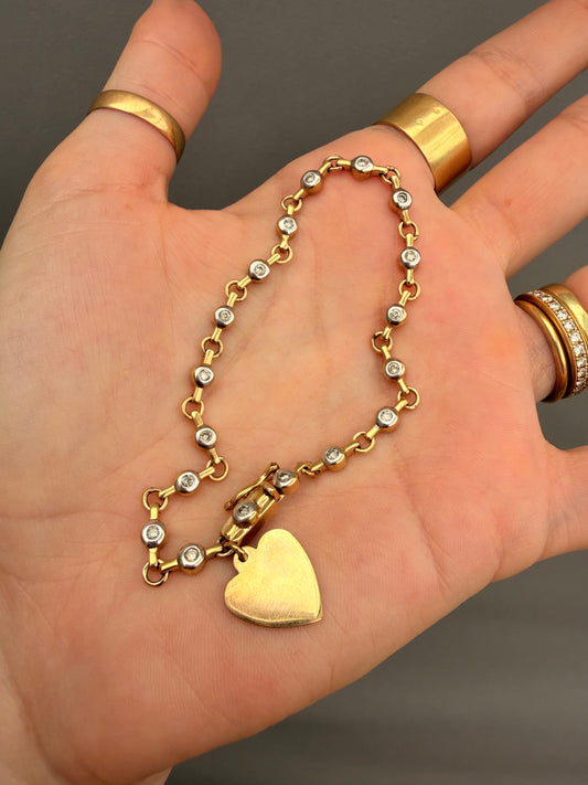 Vintage 10K approx .54ctw diamond bezel tennis bracelet with heart charm, 7.25 inch
