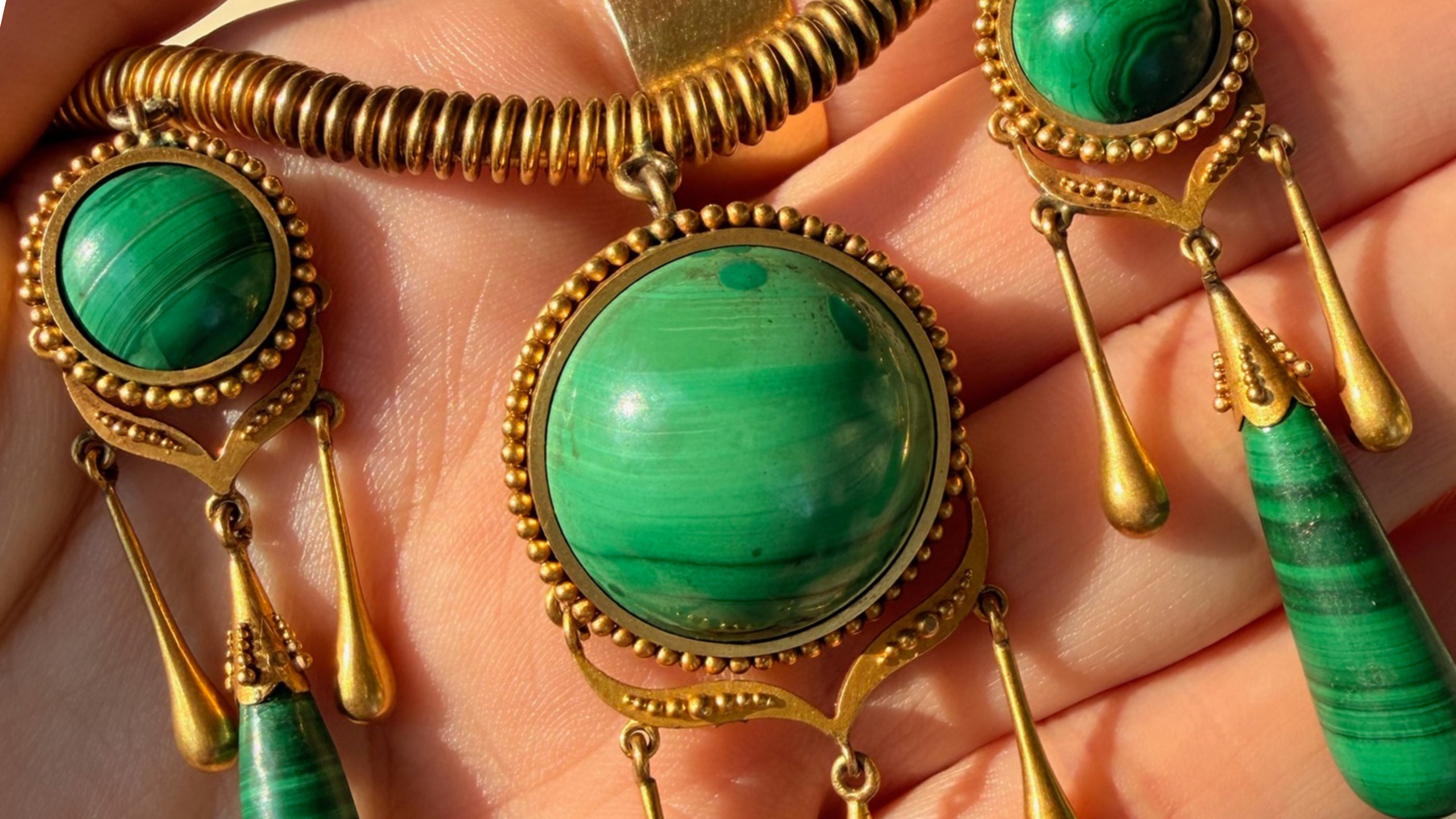 close up of exquisite malachite and gold vintage cleopatra necklace