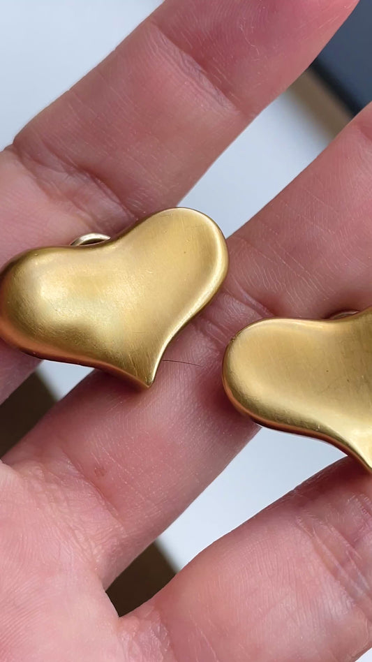 Vintage yellow 18K Angela Cummings designer satin finish heart omega back earrings from 1983